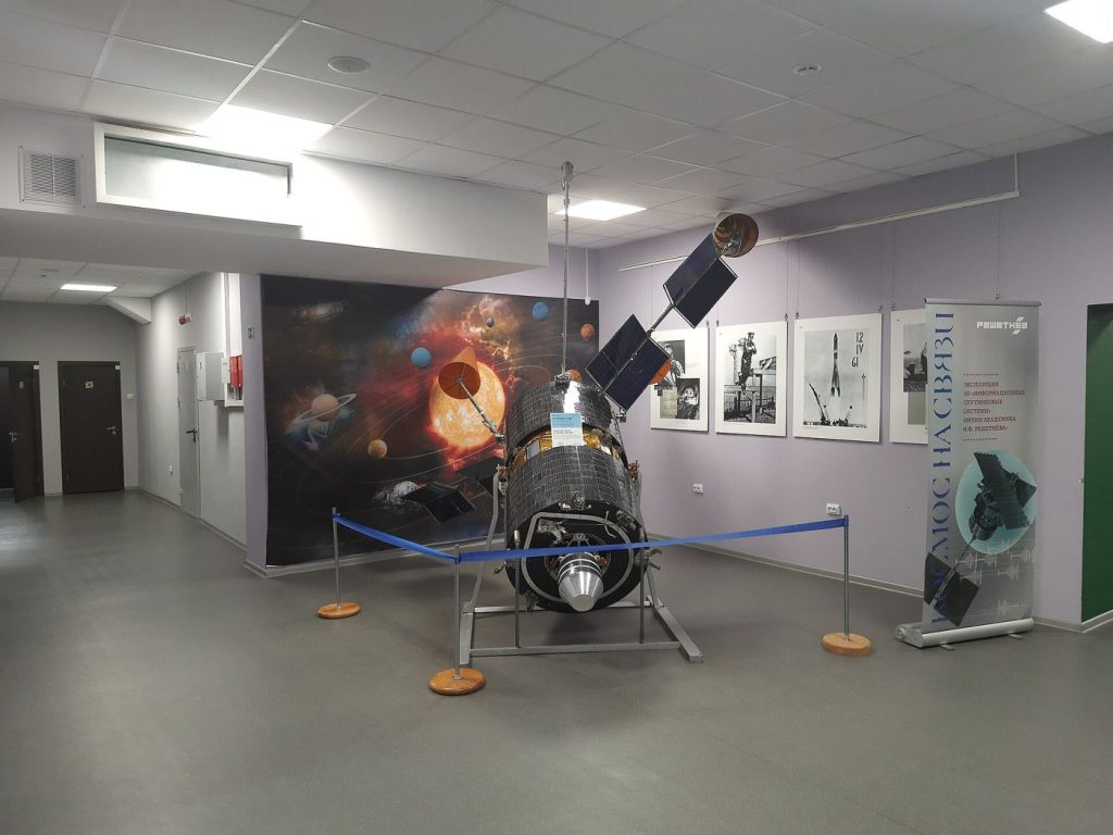 Laser Links Between Satellites Move Orbital Data Faster A communications satellite orbiting Earth with solar panels extended above the planet's curved horizon.